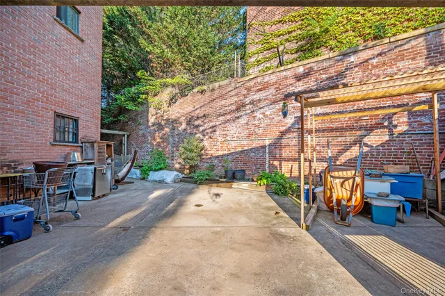 a view of a patio with table and chairs and potted plants