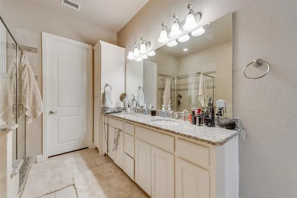 a bathroom with a double vanity sink and a mirror