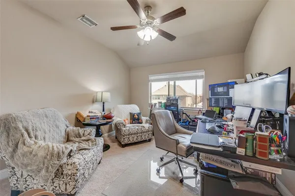 a living room with furniture and a lamp