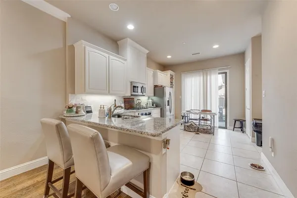 a open kitchen with stainless steel appliances granite countertop a sink and cabinets
