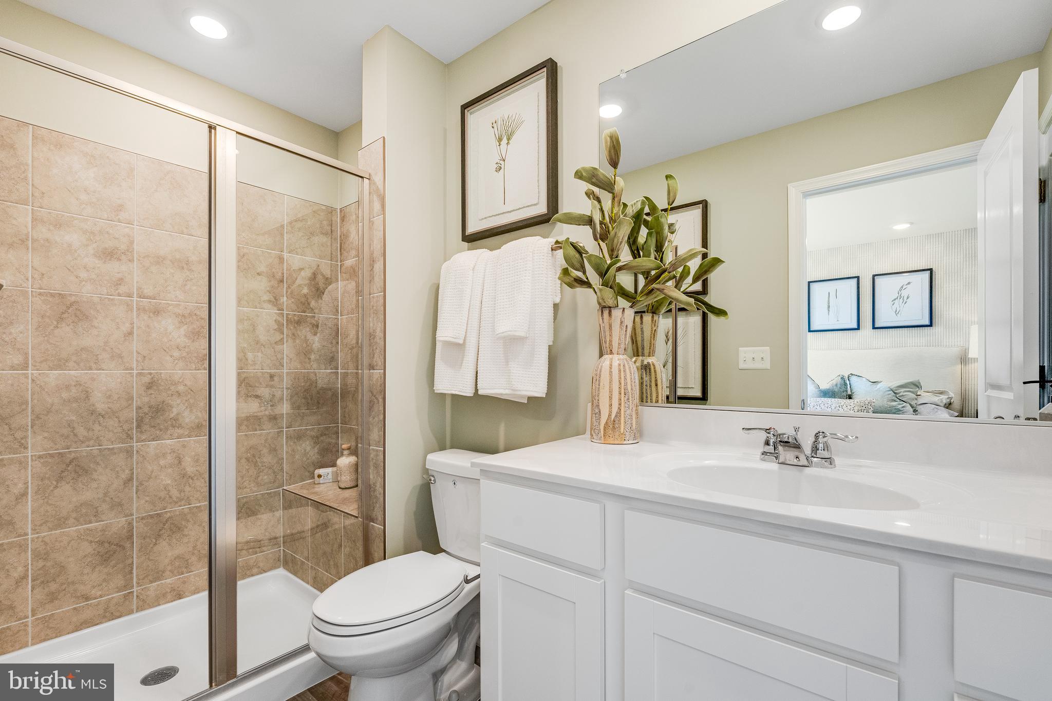 1238 Red Clover Lane Ranson, WV 25438 - Photo 20 of 21 a bathroom with a granite countertop sink a toilet and a shower