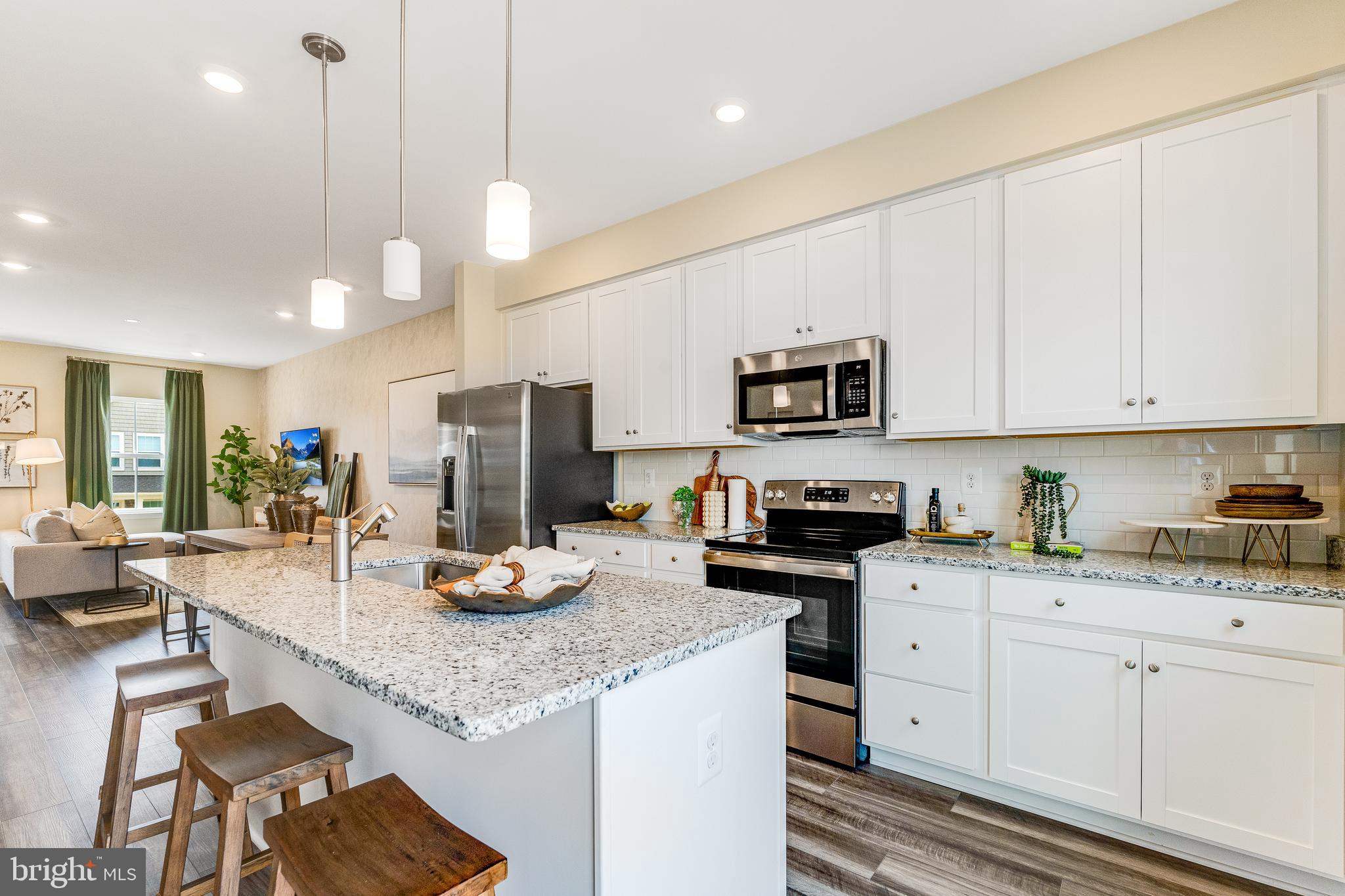 1238 Red Clover Lane Ranson, WV 25438 - Photo 2 of 21 a kitchen with granite countertop a sink cabinets and stainless steel appliances