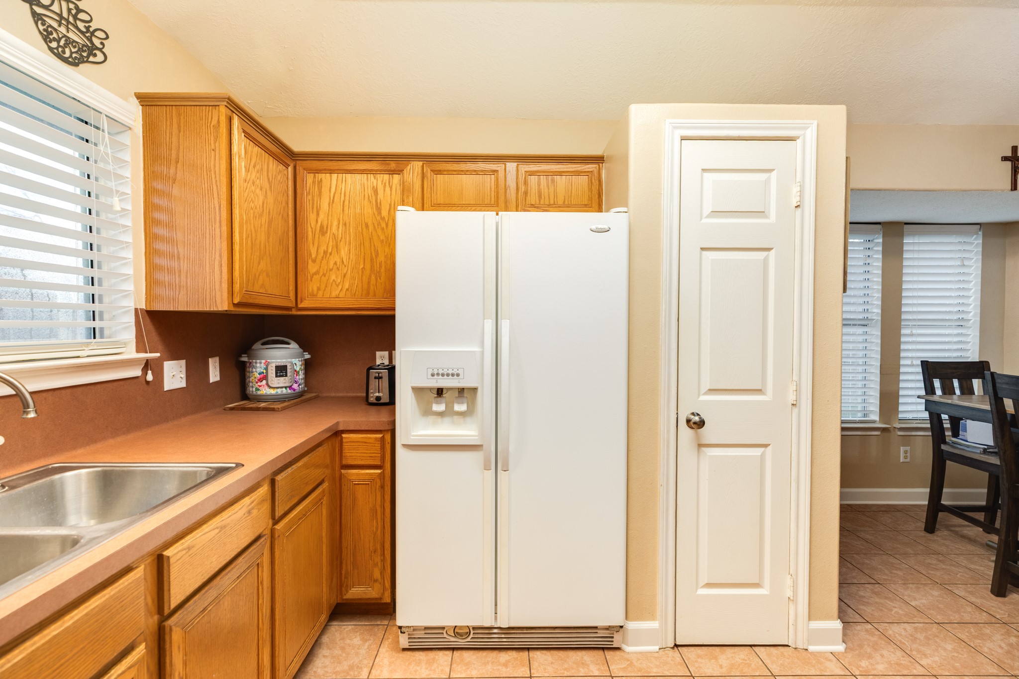 1187 Thomas Drive Angleton, TX 77515 - Photo 13 of 24 a kitchen with stainless steel appliances granite countertop a refrigerator and a sink