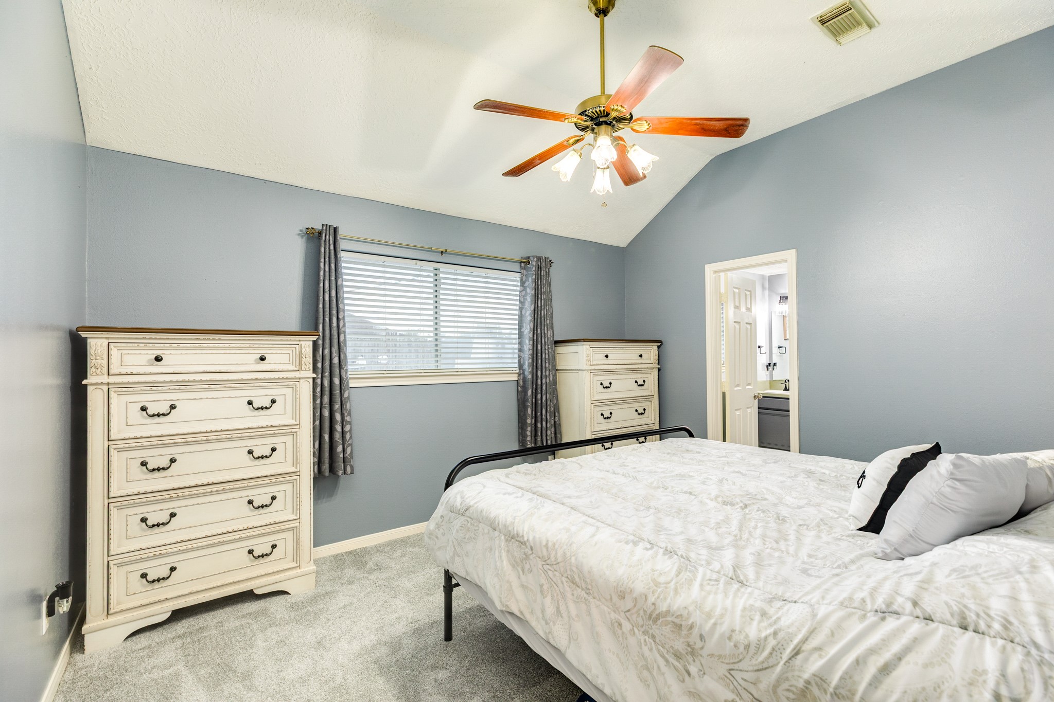 1187 Thomas Drive Angleton, TX 77515 - Photo 14 of 24 a bedroom with a bed and a chandelier