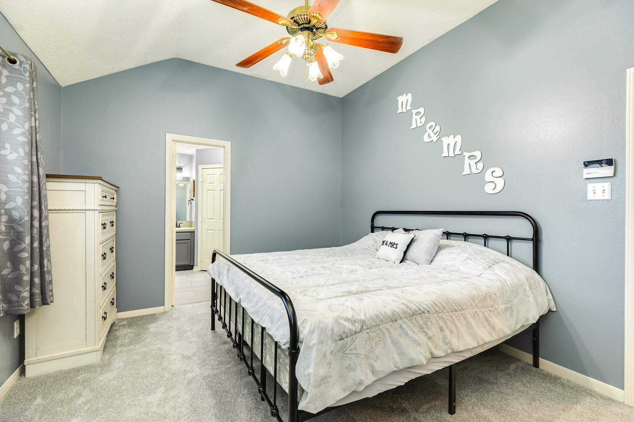 1187 Thomas Drive Angleton, TX 77515 - Photo 15 of 24 a bedroom with a bed and a chandelier