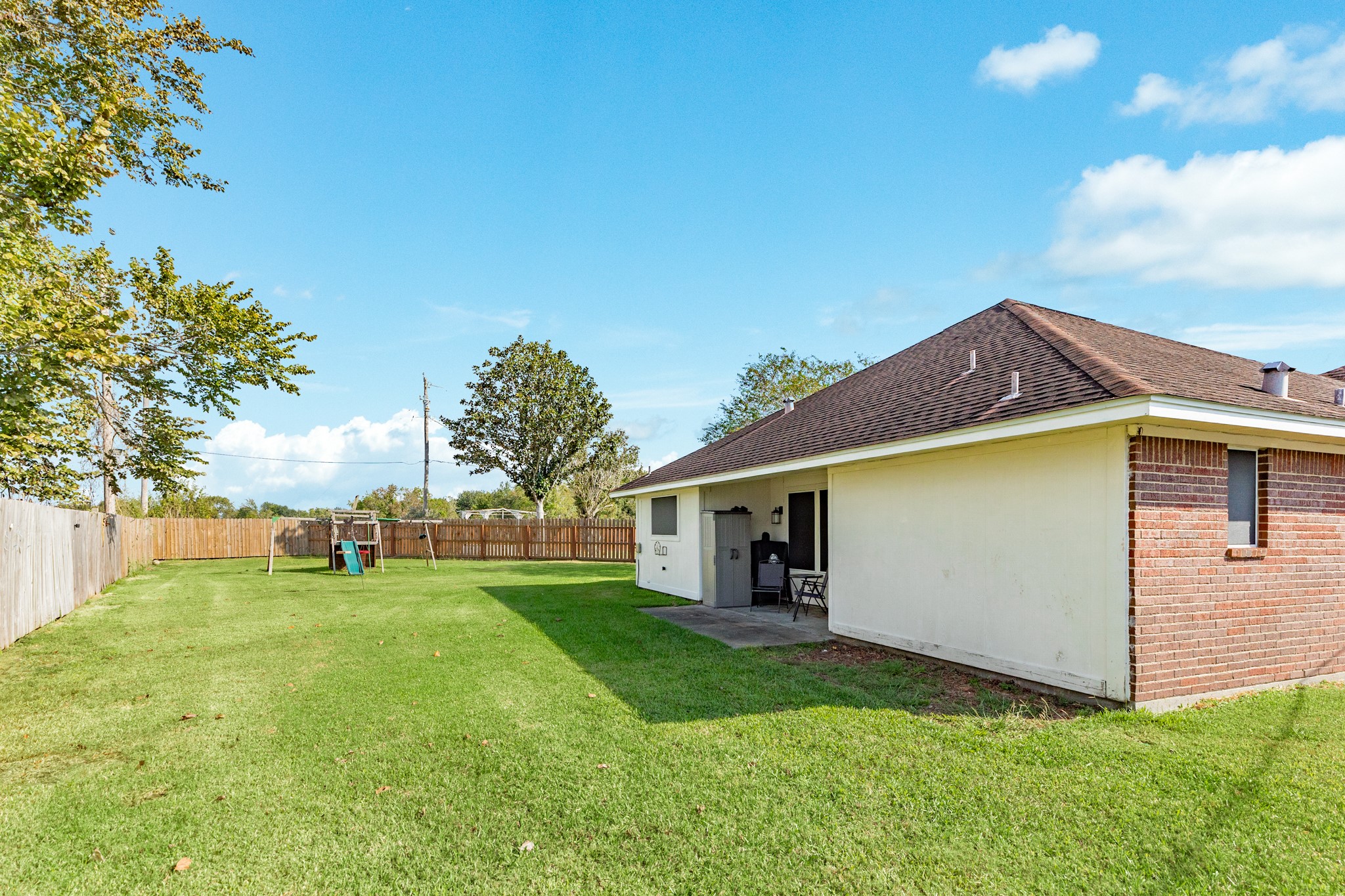 1187 Thomas Drive Angleton, TX 77515 - Photo 22 of 24 a view of a house with a yard