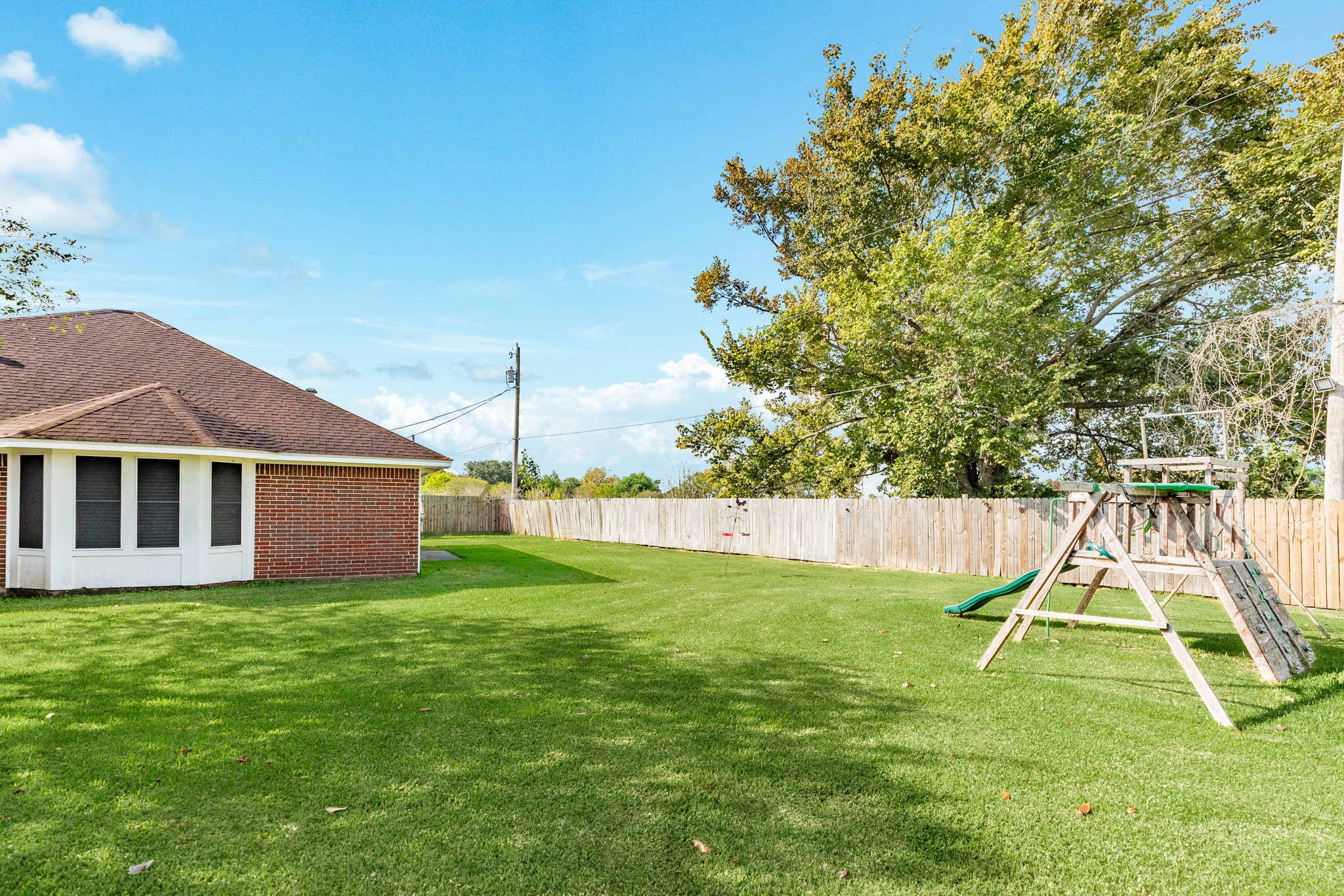 1187 Thomas Drive Angleton, TX 77515 - Photo 24 of 24 a view of a house with a yard