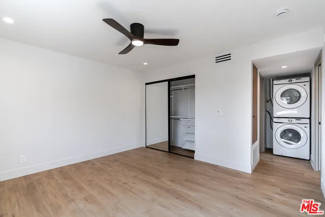a view of a livingroom with a ceiling fan and wooden floor