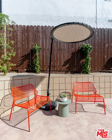 a view of backyard with swimming pool and sitting area