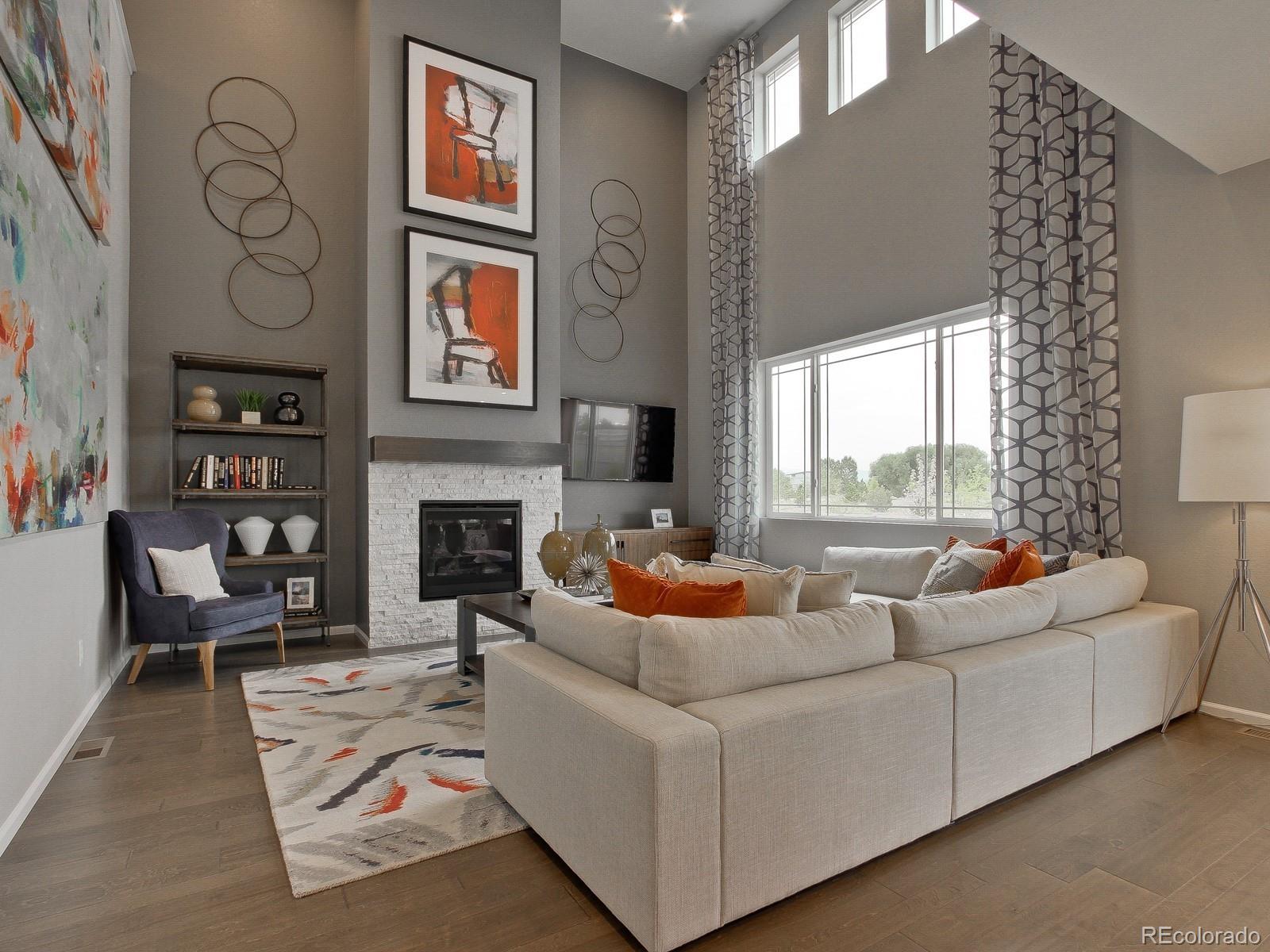 9196 Rifle Street Commerce City, CO 80022 - Photo 14 of 40 a living room with furniture and a fireplace