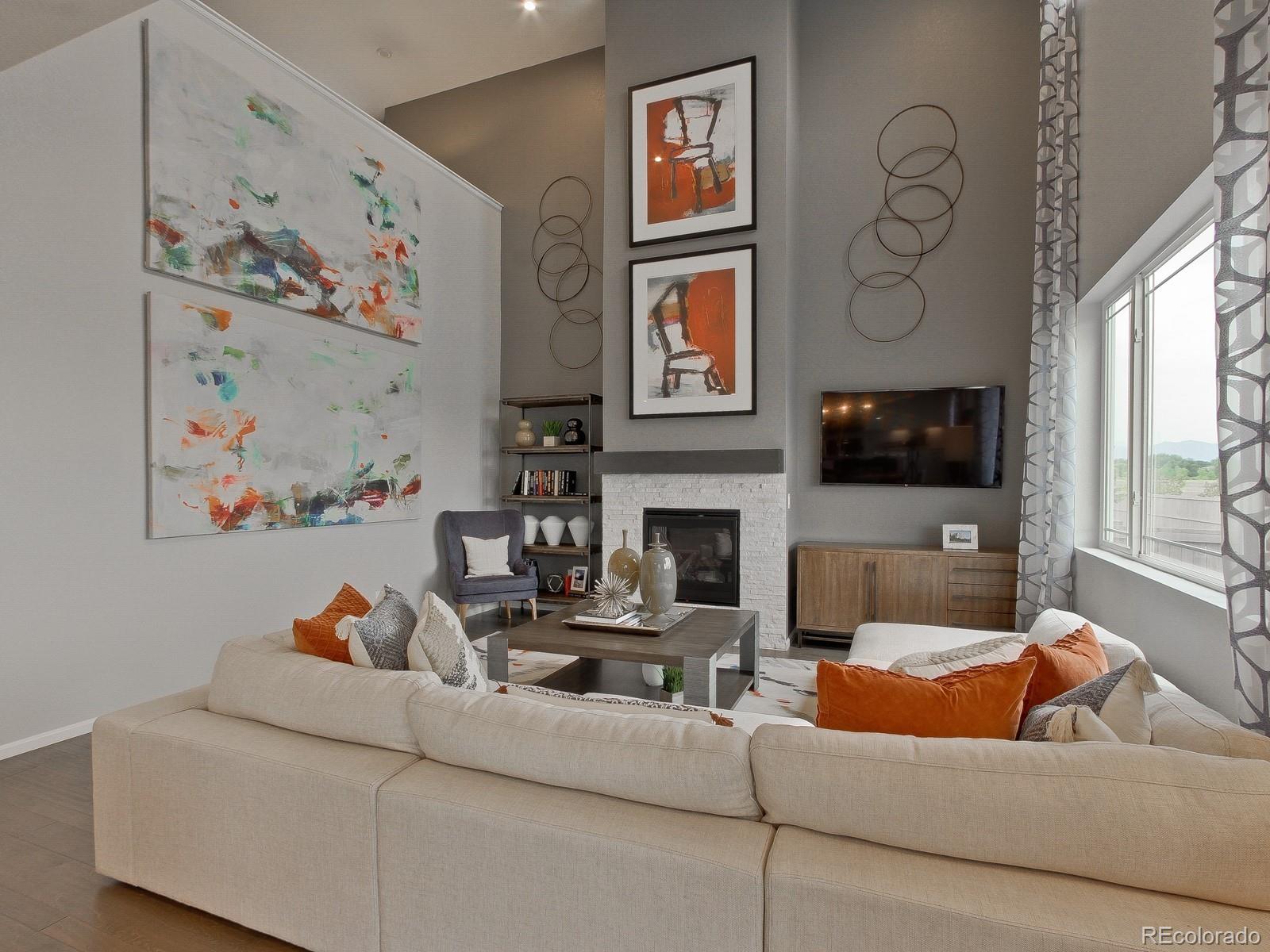 9196 Rifle Street Commerce City, CO 80022 - Photo 15 of 40 a living room with fireplace furniture and a flat screen tv