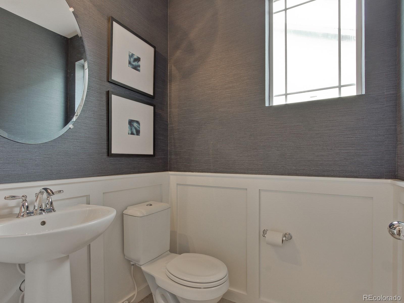 9196 Rifle Street Commerce City, CO 80022 - Photo 17 of 40 a bathroom with a toilet sink and mirror