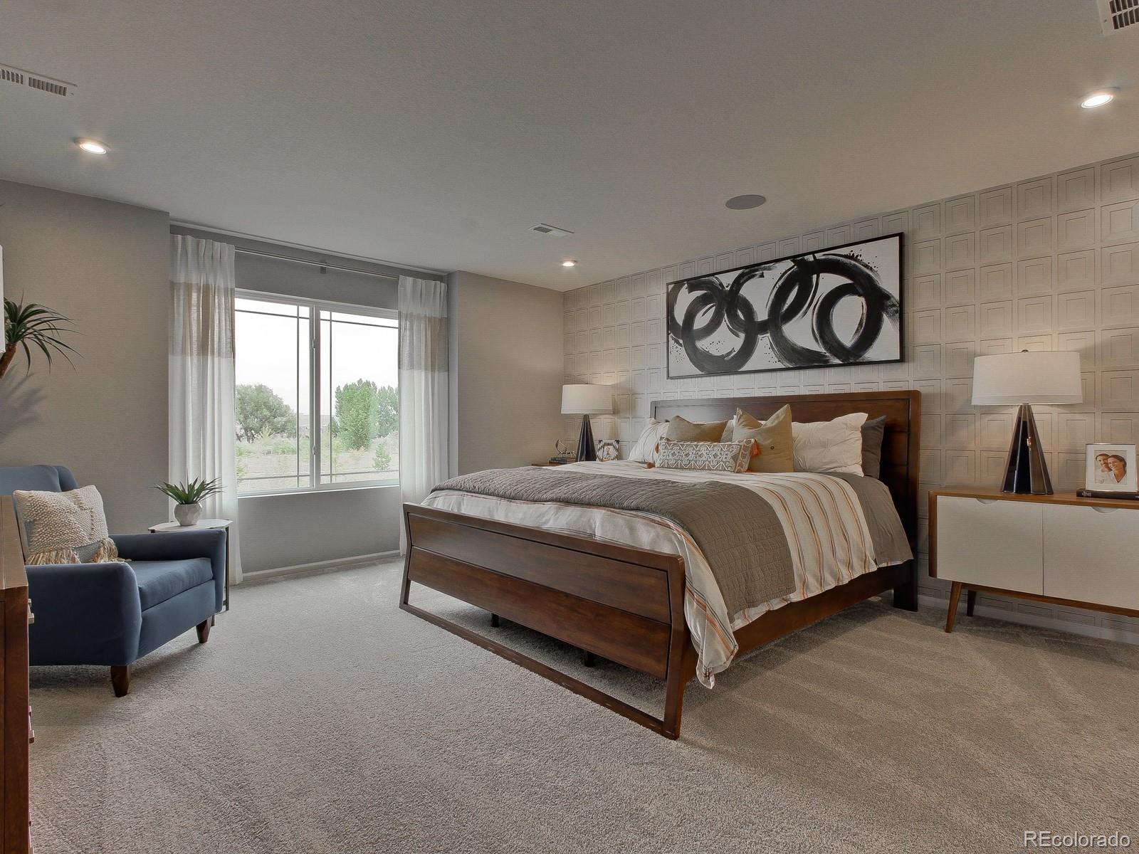 9196 Rifle Street Commerce City, CO 80022 - Photo 22 of 40 a bedroom with a bed and glass window