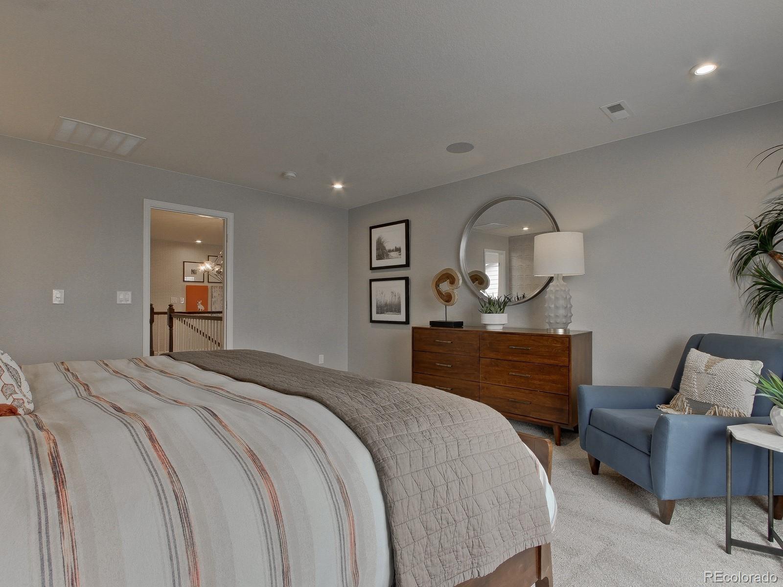 9196 Rifle Street Commerce City, CO 80022 - Photo 23 of 40 a bedroom with a bed window and a mirror on dresser