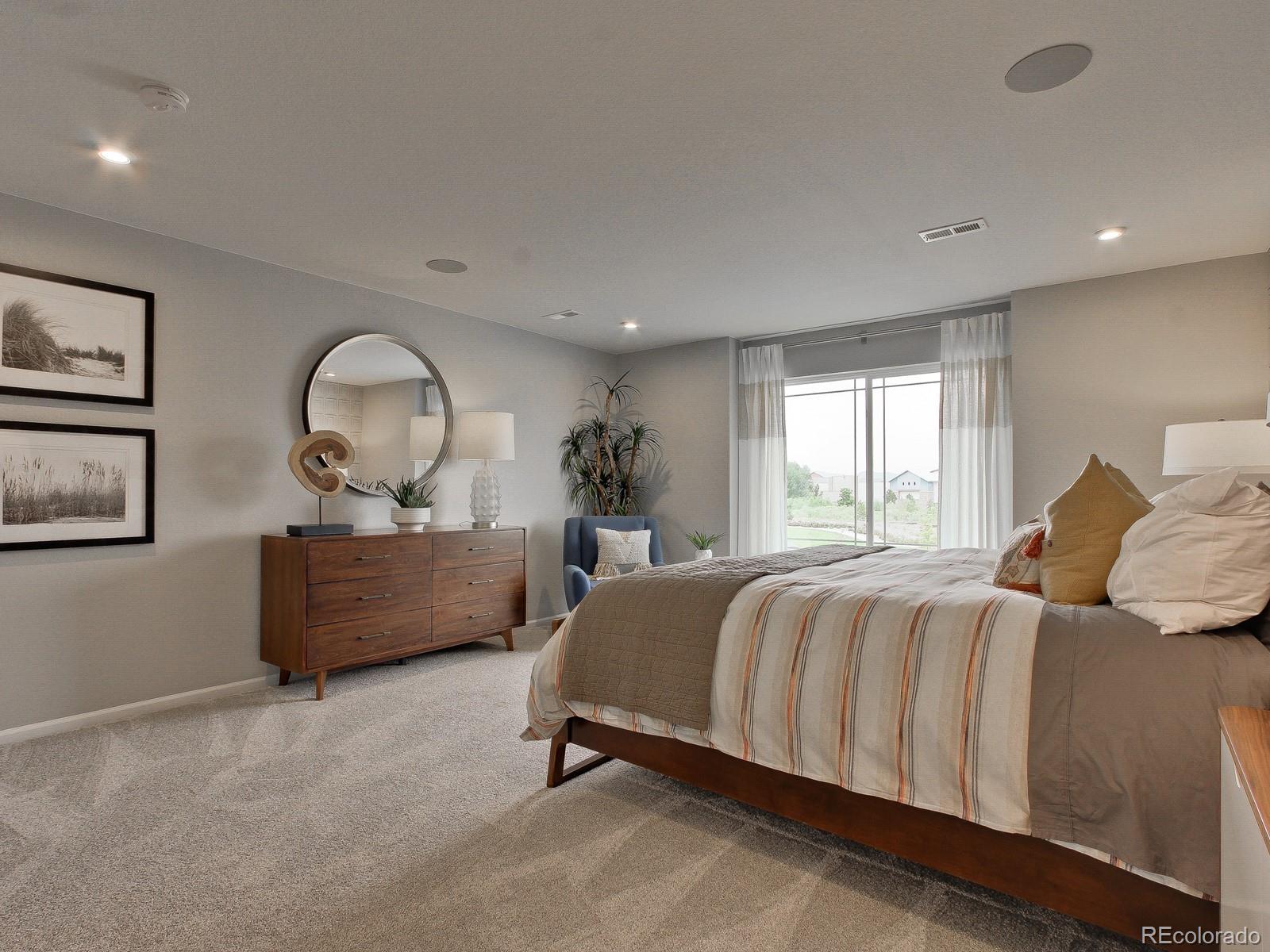 9196 Rifle Street Commerce City, CO 80022 - Photo 24 of 40 a bed room with a bed and window