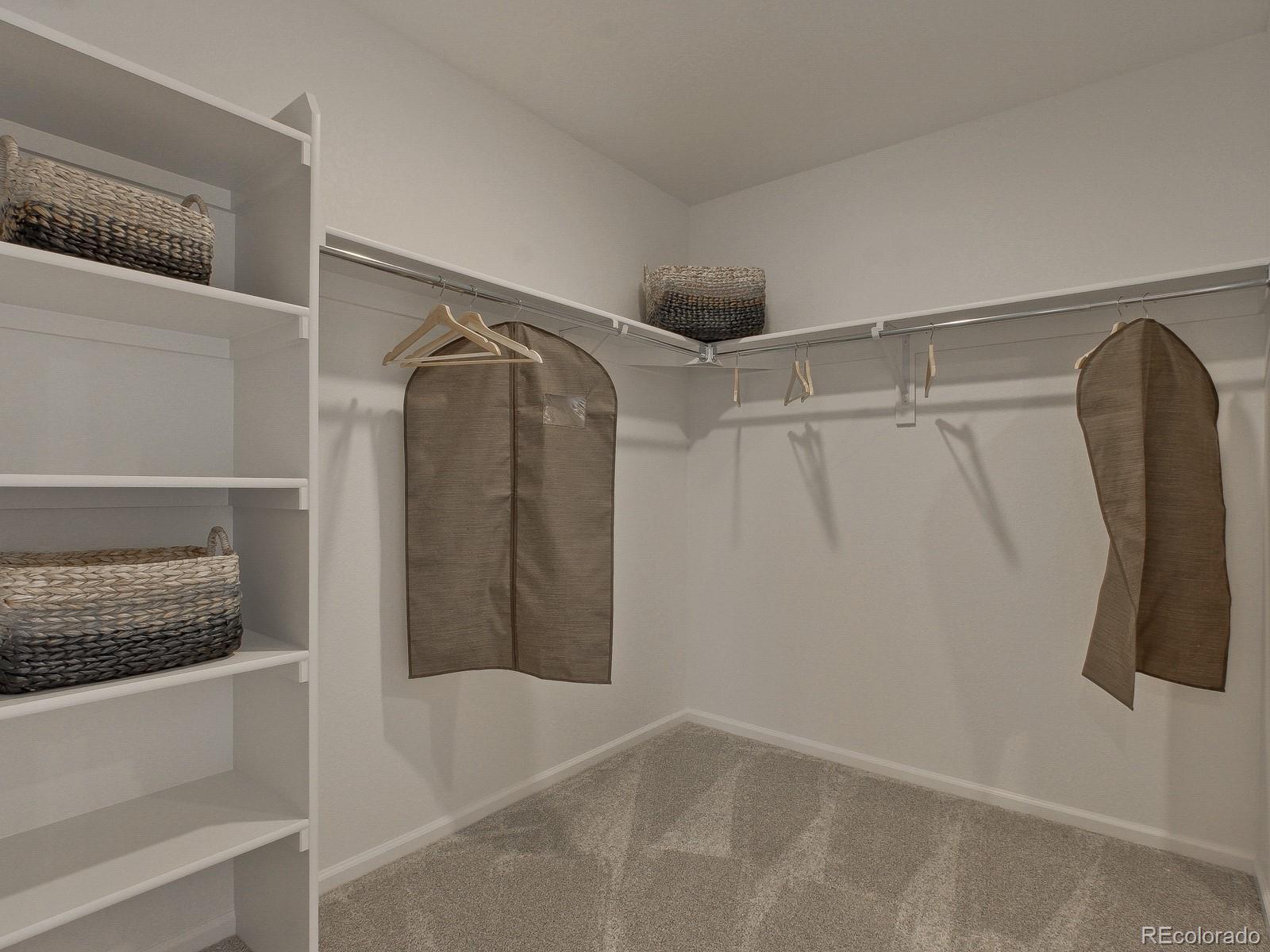 9196 Rifle Street Commerce City, CO 80022 - Photo 29 of 40 a view of walk in closet with clothes and shoes