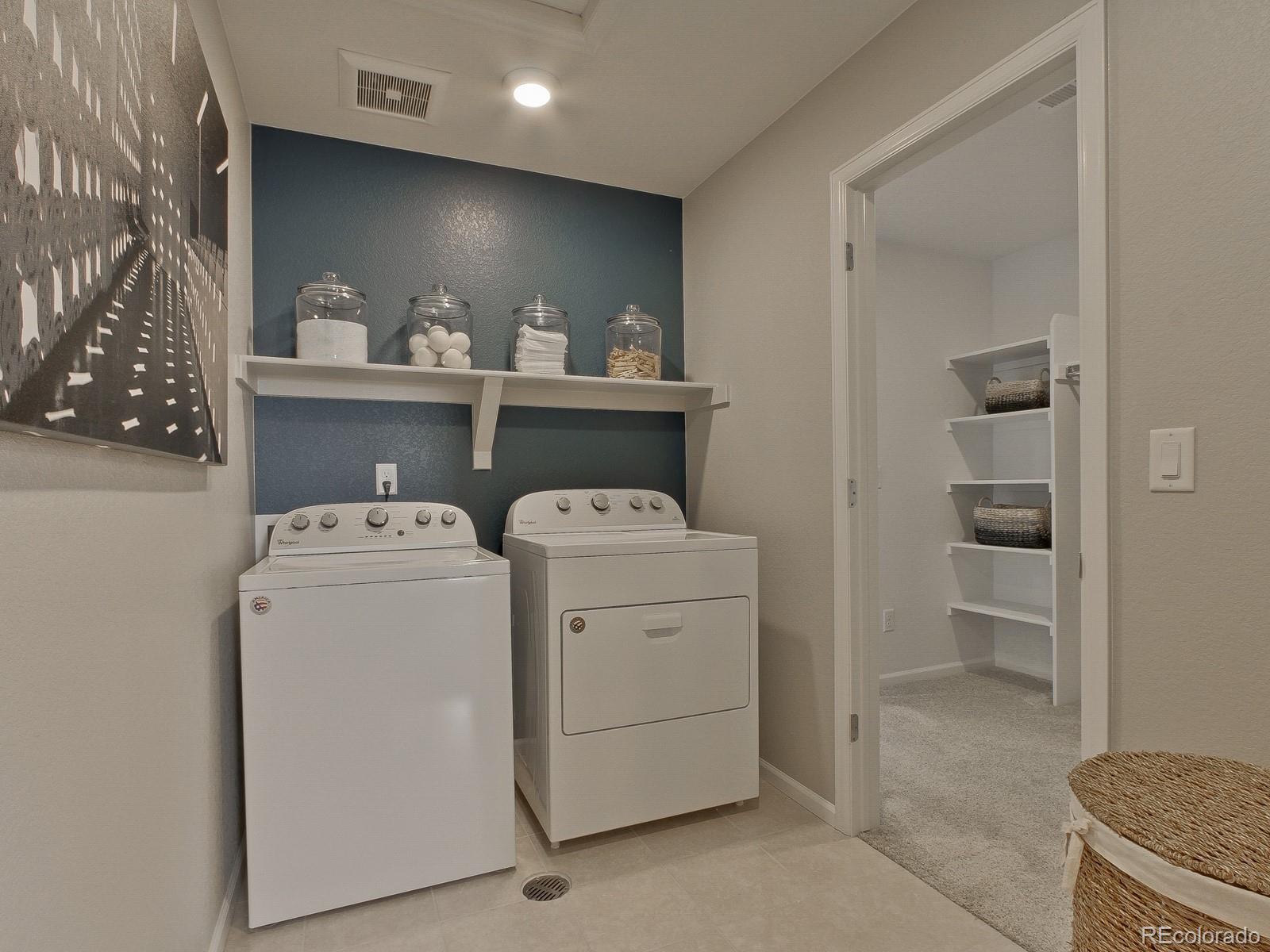9196 Rifle Street Commerce City, CO 80022 - Photo 30 of 40 a view of washer and dryer with bathroom in the background