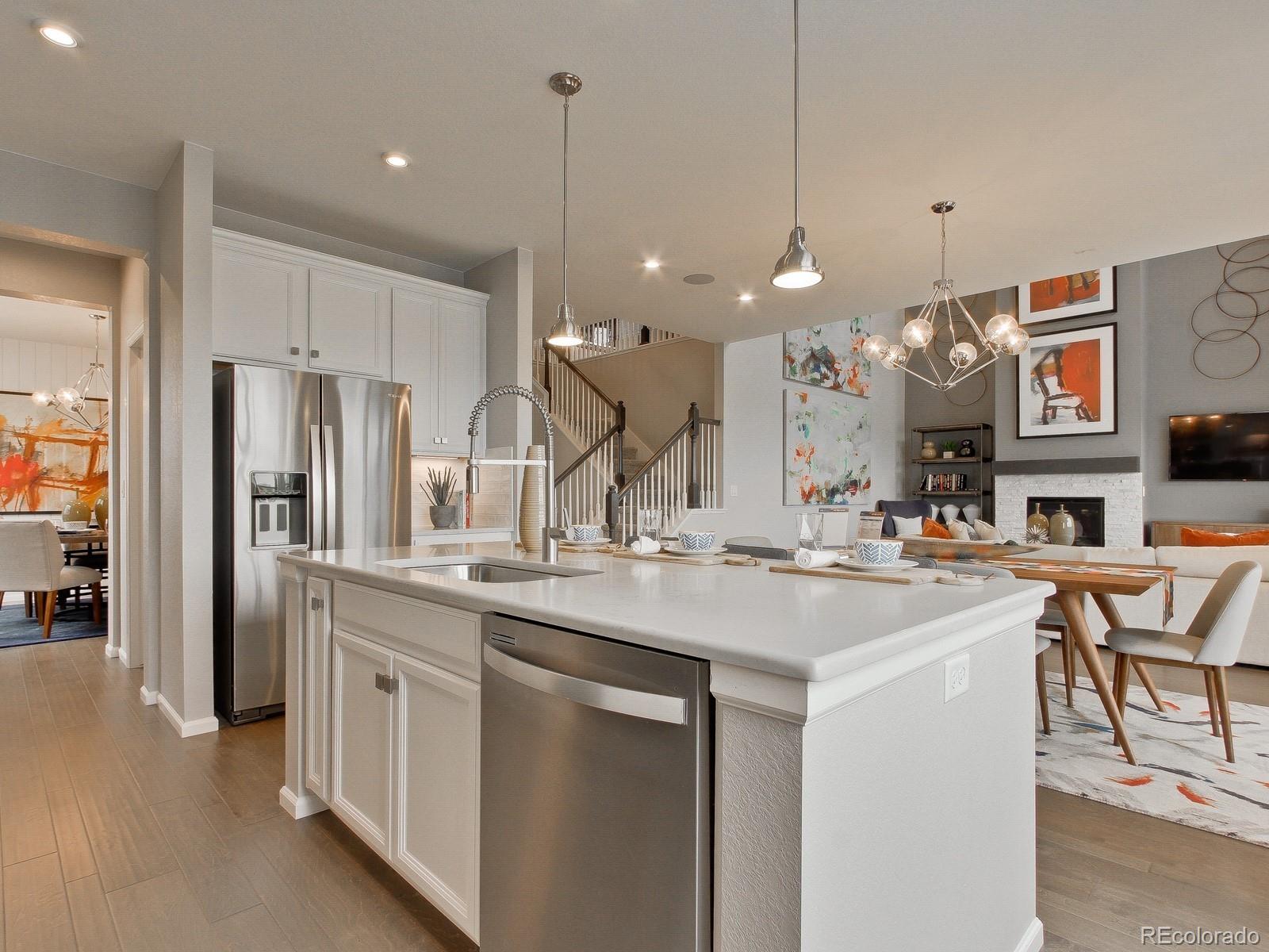 9196 Rifle Street Commerce City, CO 80022 - Photo 3 of 40 a kitchen with stainless steel appliances kitchen island a large island in the center