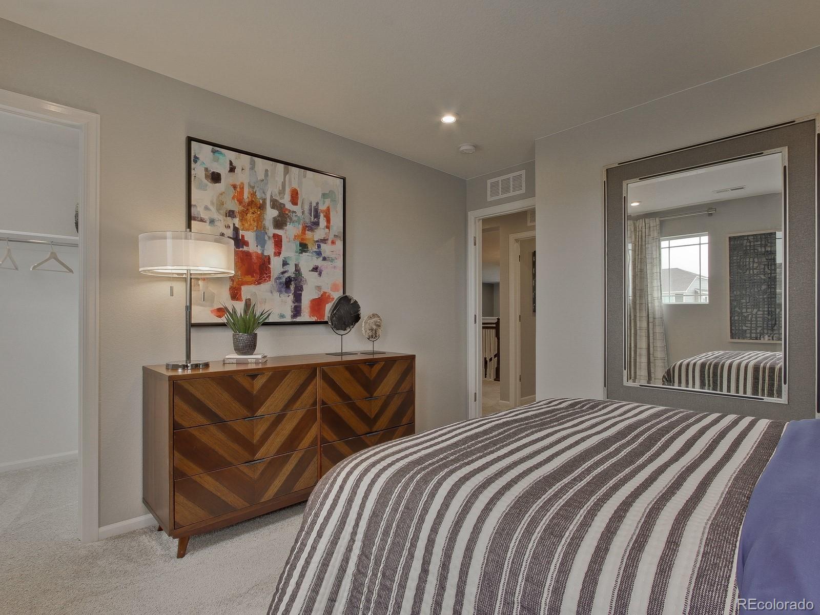 9196 Rifle Street Commerce City, CO 80022 - Photo 32 of 40 a bedroom with bed and wall painting