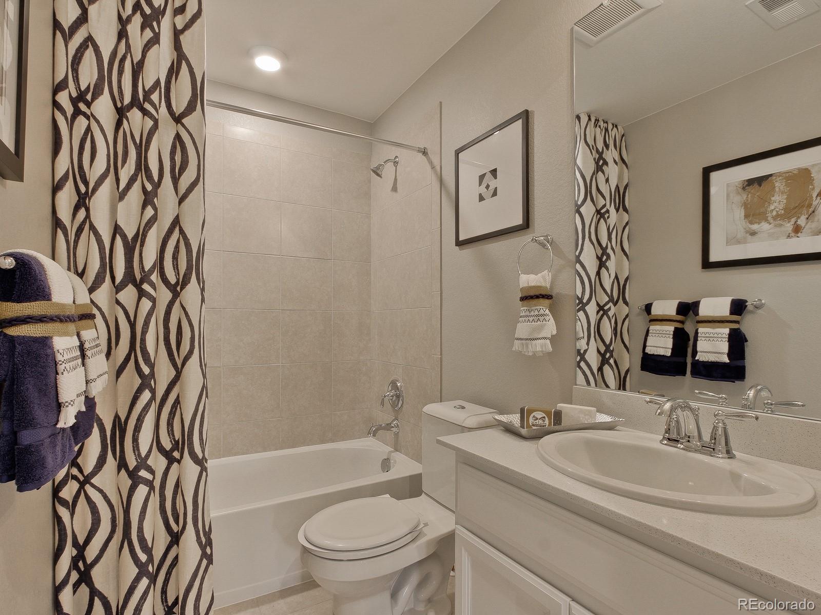 9196 Rifle Street Commerce City, CO 80022 - Photo 33 of 40 a bathroom with a toilet sink vanity tub and shower
