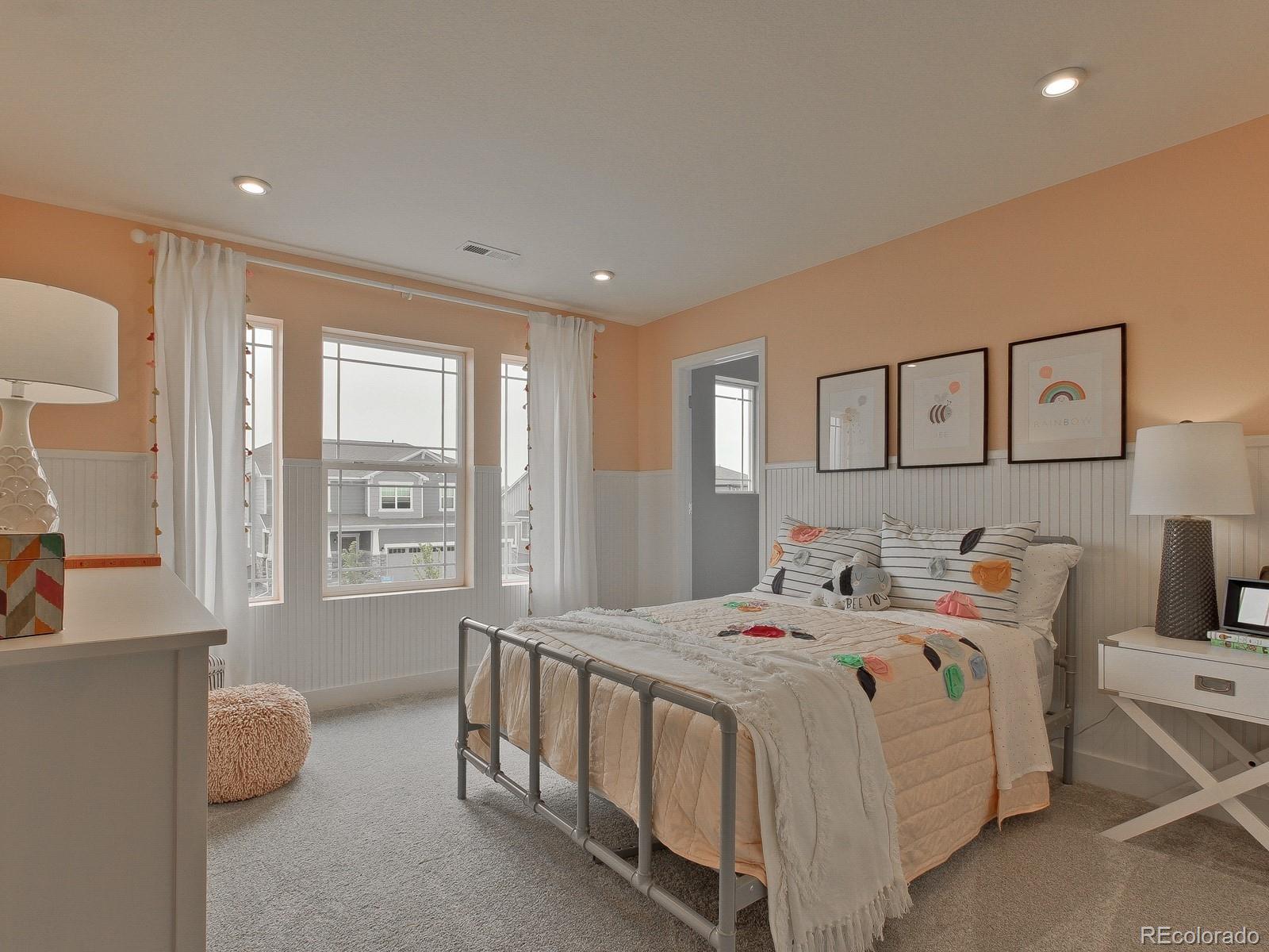 9196 Rifle Street Commerce City, CO 80022 - Photo 34 of 40 a bedroom with a bed and a large window