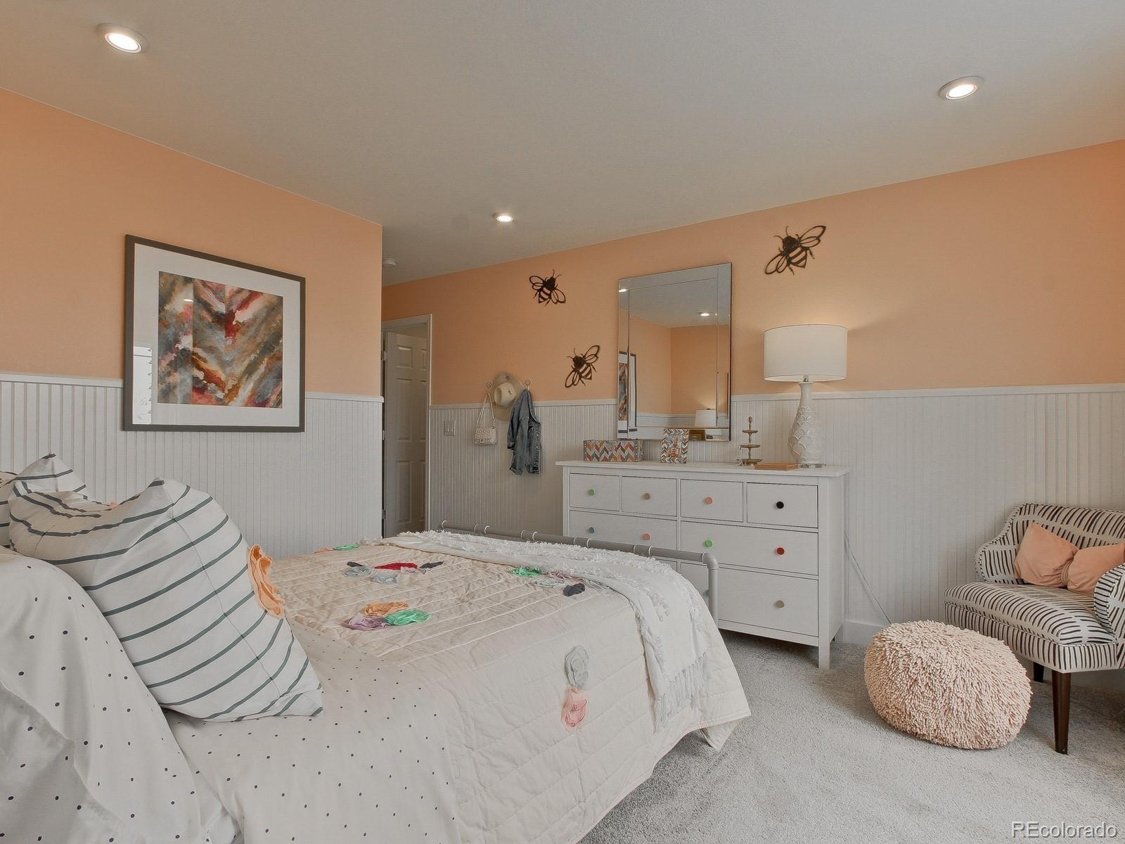 9196 Rifle Street Commerce City, CO 80022 - Photo 35 of 40 a bedroom with a bed and a painting on the wall