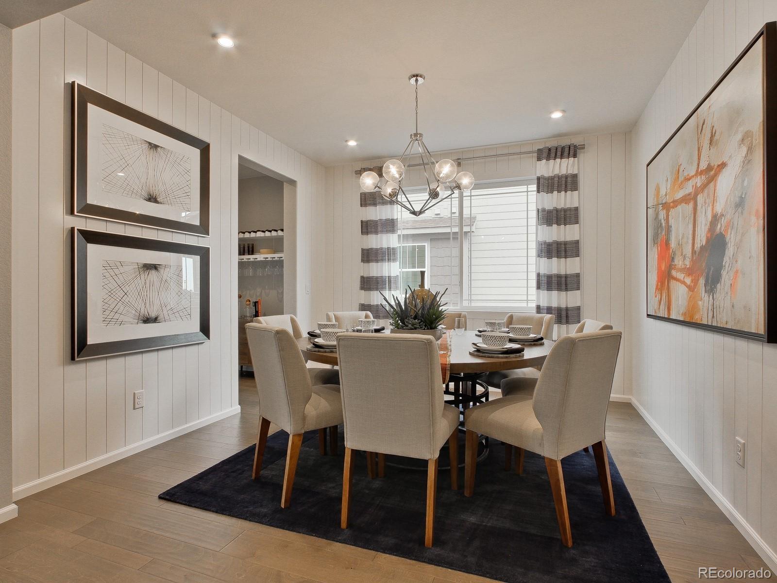 9196 Rifle Street Commerce City, CO 80022 - Photo 5 of 40 a view of a dining room with furniture wooden floor and chandelier