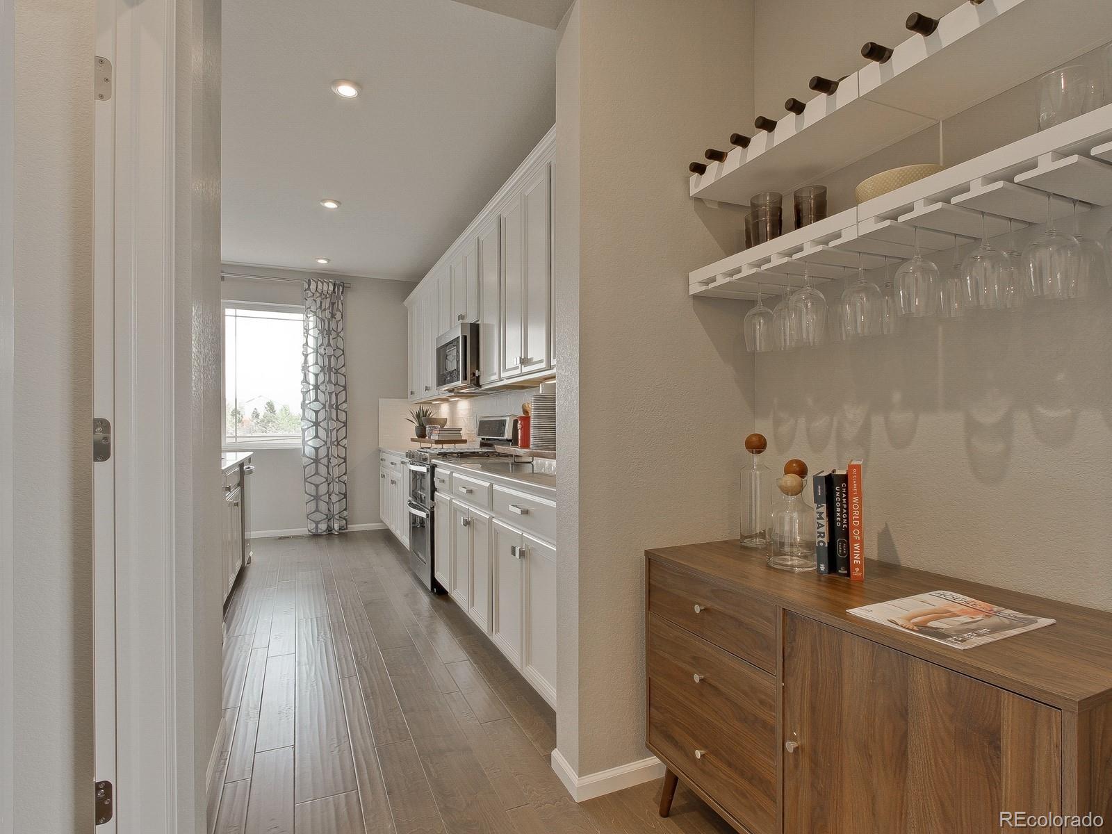 9196 Rifle Street Commerce City, CO 80022 - Photo 7 of 40 a kitchen with cabinets and window