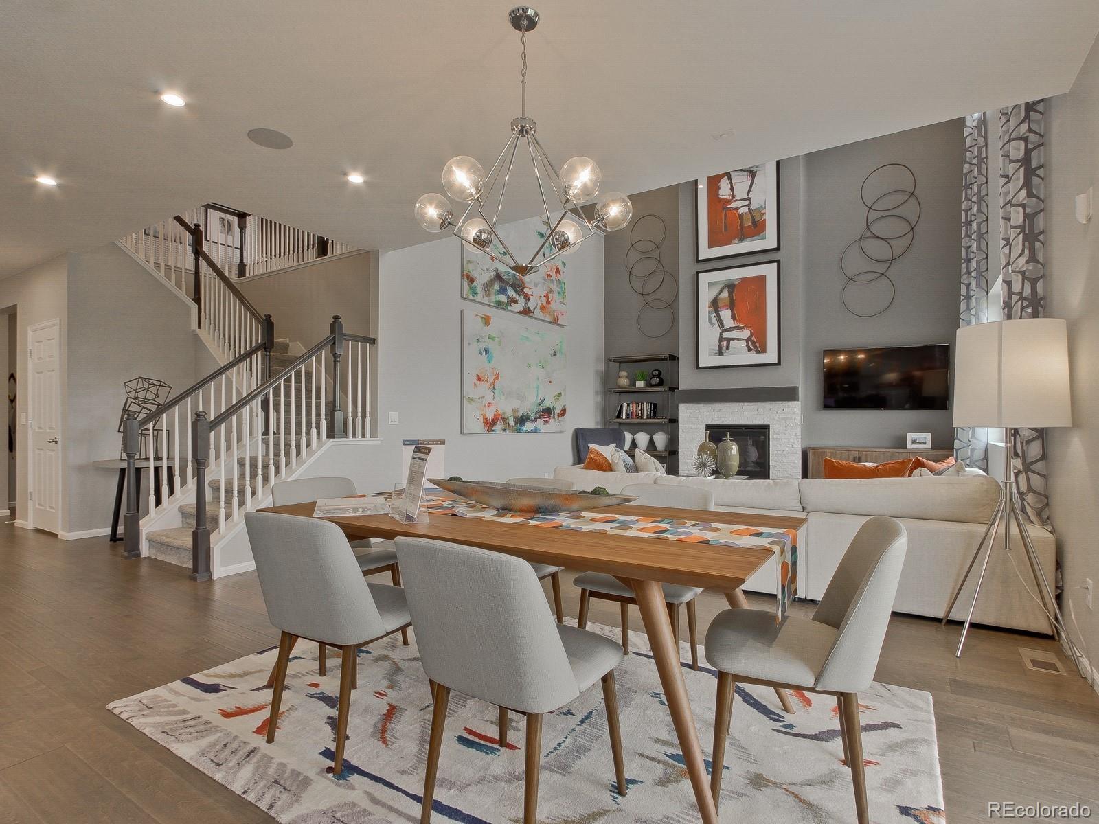 9196 Rifle Street Commerce City, CO 80022 - Photo 8 of 40 a dining room with furniture a rug and wooden floor