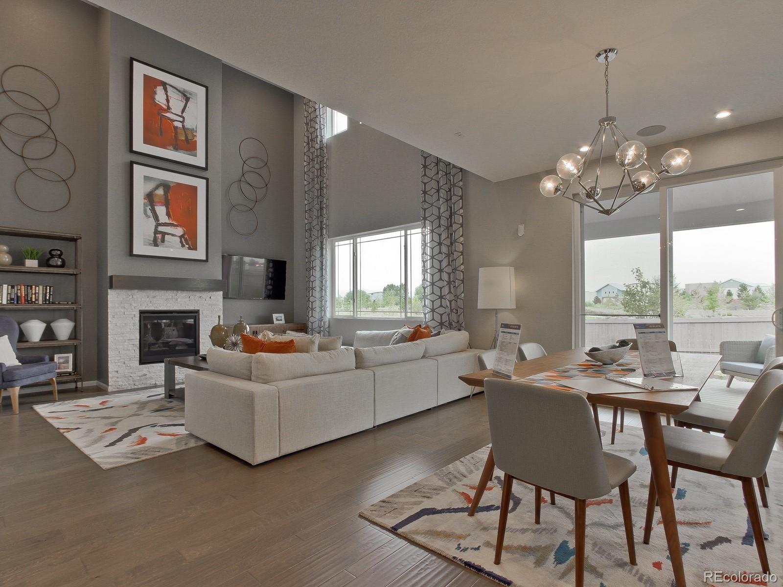 9196 Rifle Street Commerce City, CO 80022 - Photo 9 of 40 a living room with fireplace furniture and a large window