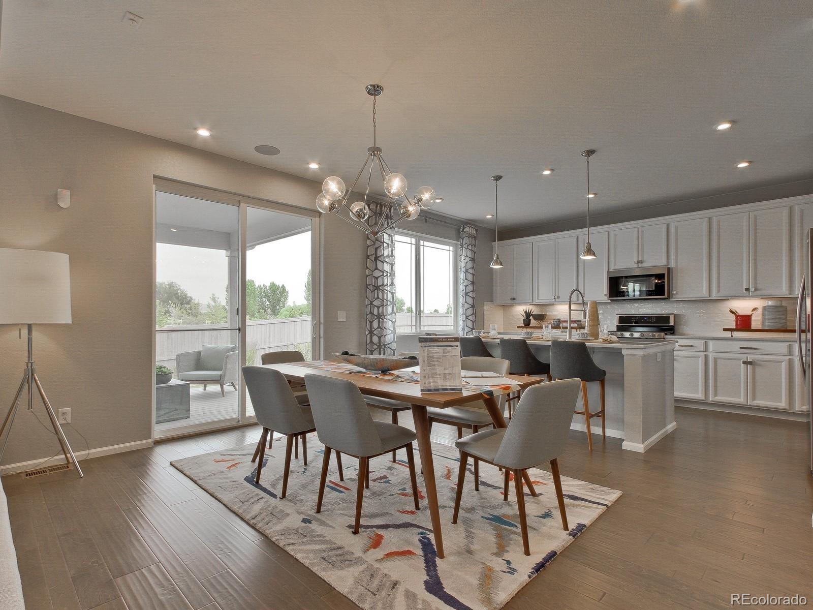 9196 Rifle Street Commerce City, CO 80022 - Photo 10 of 40 a large kitchen with a table and chairs
