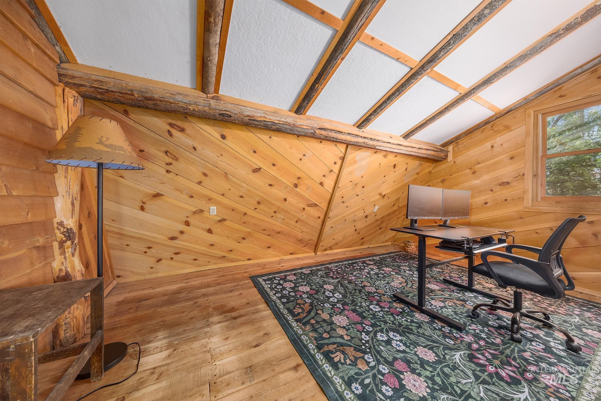 2150 Seid Creek Road Cambridge, ID 83610 - Photo 26 of 50 Wood-paneled room featuring a sloped ceiling with exposed wood beams and white panels, light wood-finish flooring, and a single window