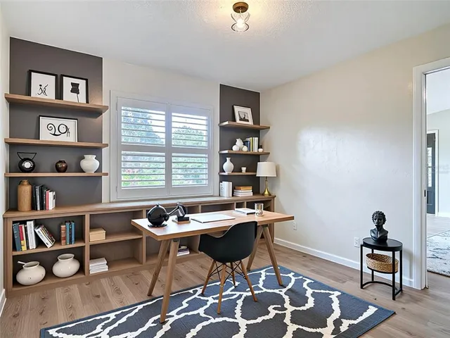a workspace with furniture and a book shelf