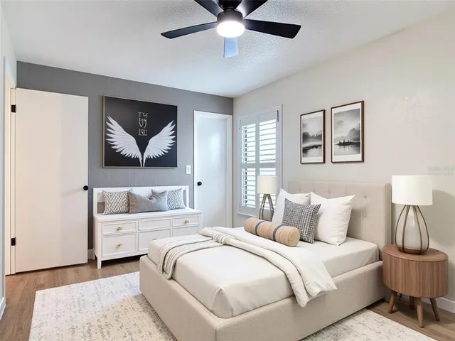 a bedroom with a bed and a painting on the wall