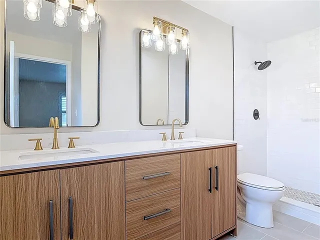 a bathroom with 2 sink and a mirror