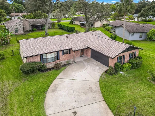 an aerial view of a house with a yard