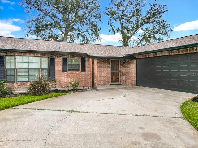 a front view of a house with a yard and a garage