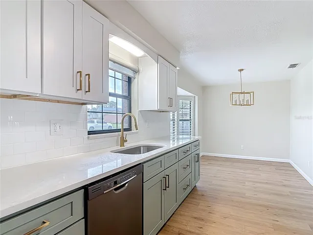 a kitchen with a sink and cabinets