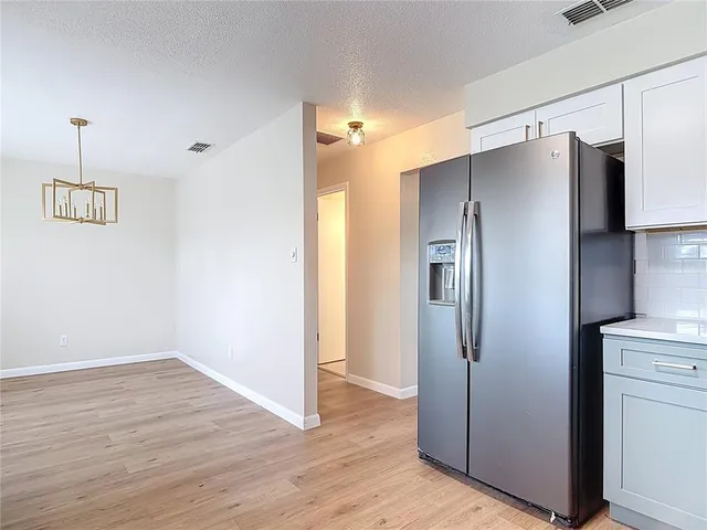 a view of a refrigerator in kitchen and wooden floor