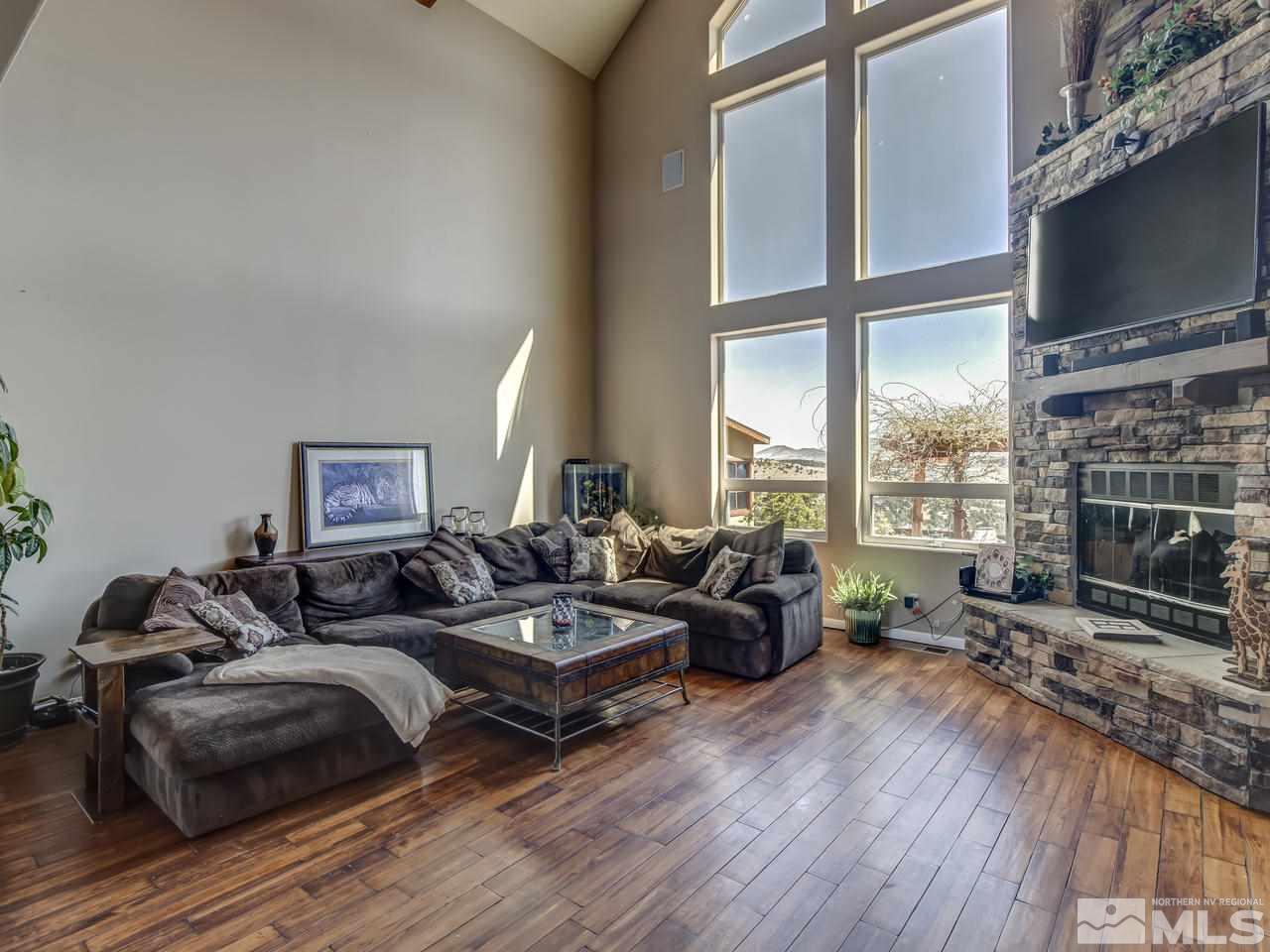21575 Colt Drive Reno, NV 89521 - Photo 2 of 20 a living room with furniture a flat screen tv and a large window