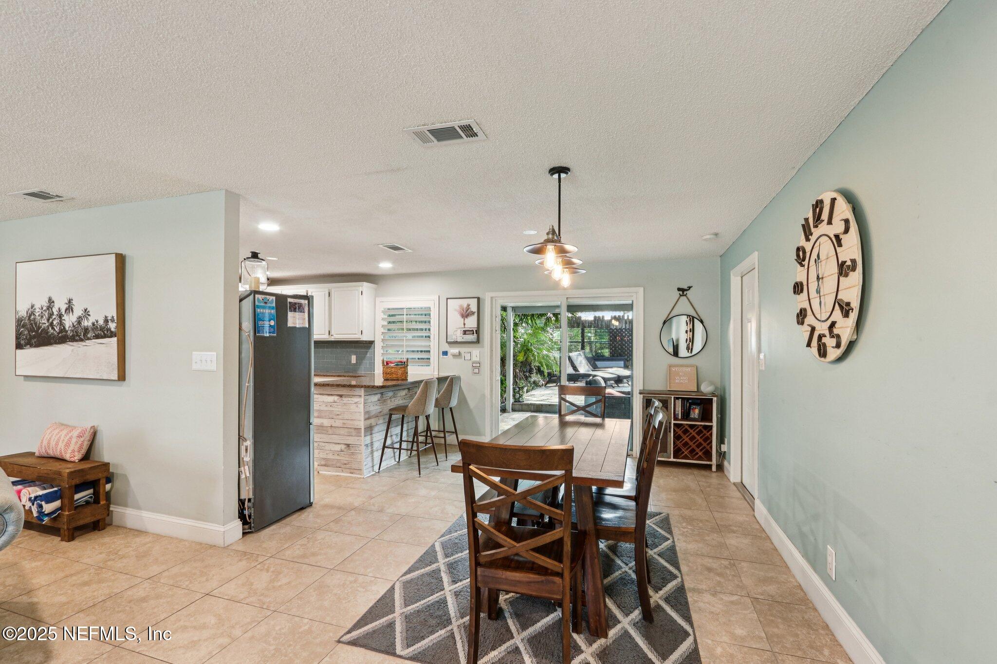 409 Seventeenth Street St. Augustine, FL 32084 - Photo 12 of 42 a view of a dining room and livingroom with furniture window and wooden floor