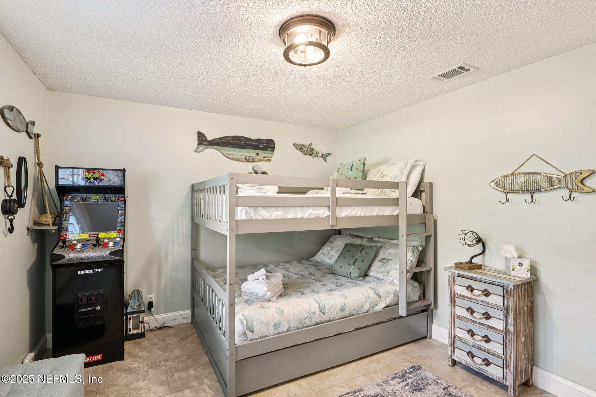 409 Seventeenth Street St. Augustine, FL 32084 - Photo 21 of 42 a bedroom with a bed and wooden floor