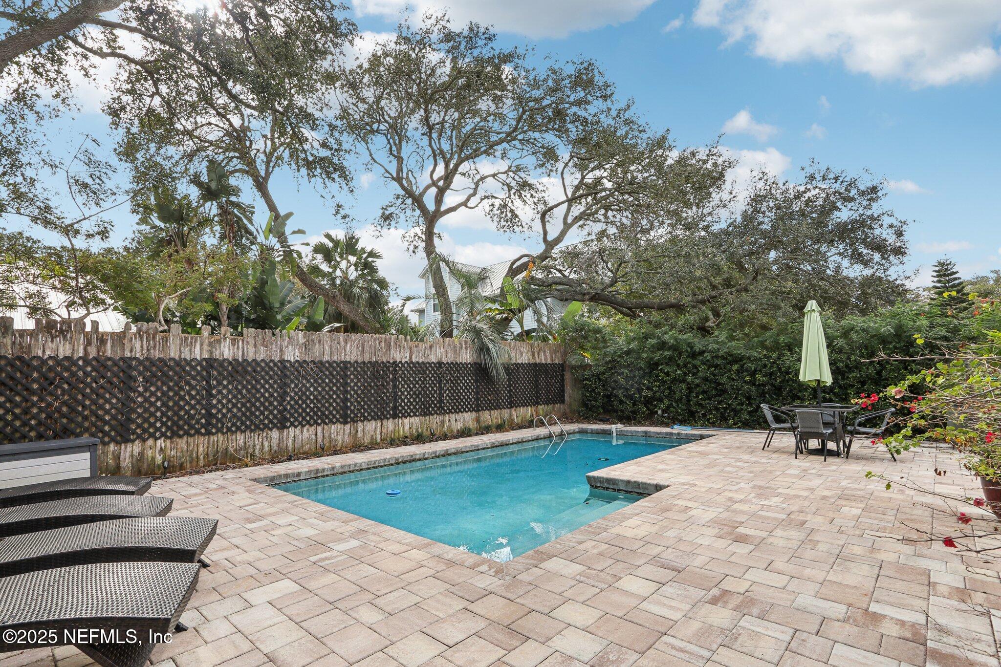 409 Seventeenth Street St. Augustine, FL 32084 - Photo 34 of 42 a view of a backyard with a bench and potted plants