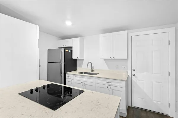 a kitchen with a sink a stove and refrigerator