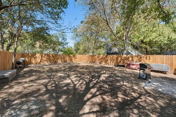 a backyard of a house with table and chairs