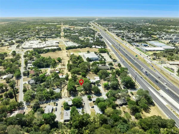 an aerial view of residential houses with city view