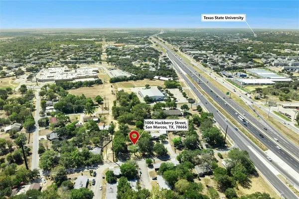 an aerial view of residential houses with city view