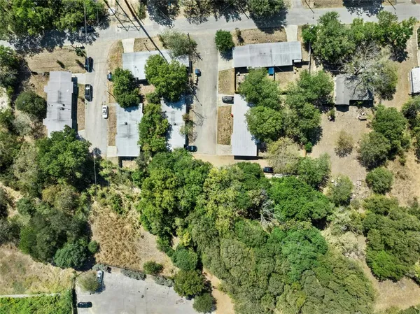 an aerial view of a house with a yard and outdoor seating