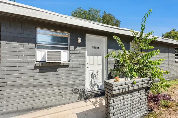 a front view of a house with outdoor seating and plants