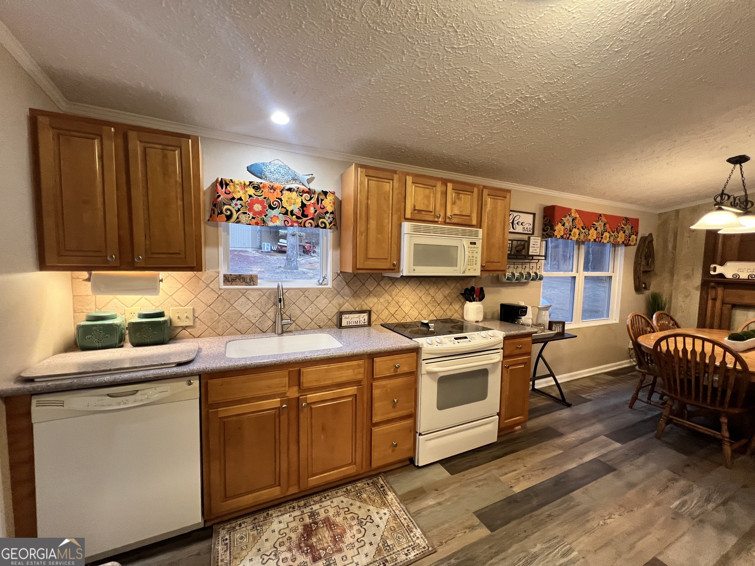 64 Bay Point Sparta, GA 31087 - Photo 24 of 53 a kitchen with a sink stove and cabinets